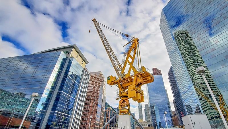 A crane is used to construct a luxury condominium in a large city.